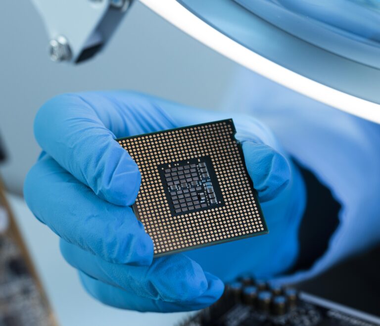 Gloved hand holding semiconductor chip
